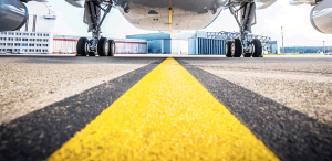 La parte baja de un avión que se encuentra en una pista para despegar